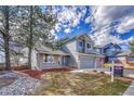 Charming two-story home with well-maintained lawn and two-car garage at 10941 Parker Vista Rd, Parker, CO 80138