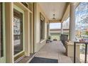 Inviting covered porch with classic columns, neutral tones, and a hanging light fixture, perfect for relaxing outdoors at 1425 N Washington St # 104, Denver, CO 80203