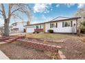 Charming single-story home featuring a tidy front yard, brick accents, and a welcoming red-brick walkway at 1811 S Norfolk St, Aurora, CO 80017