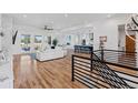 Bright open-concept living space with hardwood floors, leading to a modern kitchen and a cozy sitting area at 740 W County Road 10E, Berthoud, CO 80513