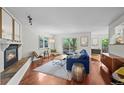 Bright living room with hardwood floors, fireplace, and sliding glass doors to an outdoor patio at 1409 Quince Ave, Boulder, CO 80304