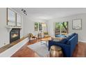 Cozy living room with fireplace, hardwood floors, and lots of natural light at 1409 Quince Ave, Boulder, CO 80304
