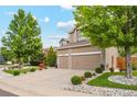 Beautiful two-story home with a two-car garage, well-manicured lawn, and lush landscaping at 18027 E Ida Dr, Centennial, CO 80015