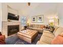 Inviting living room with a fireplace, plush seating, and a large ottoman at 2117 S Troy Way, Aurora, CO 80014