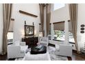 Bright living room with soaring ceilings, large windows, and comfortable seating, perfect for relaxation at 3791 Charterwood Cir, Highlands Ranch, CO 80126