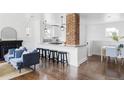 Bright living room featuring a fireplace, hardwood floors and views into the kitchen at 4828 W 32Nd Ave, Denver, CO 80212