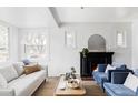 Bright living room with modern decor, a cozy fireplace, and large windows providing ample natural light at 4828 W 32Nd Ave, Denver, CO 80212
