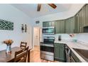 Eat-in kitchen featuring stainless steel appliances, stylish cabinetry, and a view into the next room at 3127 W 28Th Ave # 2, Denver, CO 80211