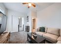 Inviting living room with a comfortable sofa, dark-stained coffee table, and neutral color palette at 3127 W 28Th Ave # 2, Denver, CO 80211