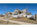 Charming two-story home with a two-car garage and quaint front porch and sidewalk at 5534 Killarney St, Denver, CO 80249