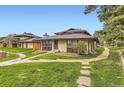Property featuring lush green lawns and a tranquil setting at 3827 S Fraser St, Aurora, CO 80014