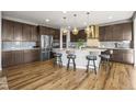 Well-appointed kitchen featuring stainless appliances, a large island and pendant lighting at 13979 Night Owl Ln, Parker, CO 80134