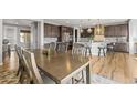 Spacious eat-in kitchen with wooden dining table, kitchen island, and modern appliances at 13979 Night Owl Ln, Parker, CO 80134