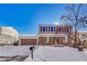 Two-story house with attached garage and snow-covered yard at 16806 E Villanova Cir, Aurora, CO 80013