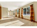 Bright and spacious living room with large windows and carpet flooring at 16806 E Villanova Cir, Aurora, CO 80013