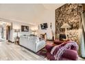 Comfortable living room with stone fireplace, contemporary furnishings, and ample lighting at 325 Four O Clock Rd # 303, Breckenridge, CO 80424