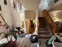 Foyer with a staircase and visible entry to the bathroom and living room at 14874 E 52Nd Ave, Denver, CO 80239