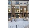 Modern brick townhome with private patio and snow-covered front yard at 4060 W 16Th Ave, Denver, CO 80204