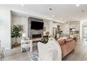 Open living room, kitchen, and breakfast bar with modern fireplace at 4060 W 16Th Ave, Denver, CO 80204