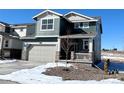 Two-story house with gray siding, attached garage, and small front yard at 241 Paloma Way, Elizabeth, CO 80107