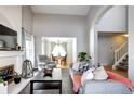 Spacious living room with fireplace, open to dining room, perfect for entertaining guests at 3889 S Fraser St, Aurora, CO 80014