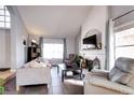 Inviting living room with fireplace, mantle, tile floors, and lots of natural light at 3889 S Fraser St, Aurora, CO 80014