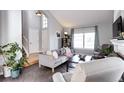 Cozy living room featuring a fireplace, tiled floors, and large windows at 3889 S Fraser St, Aurora, CO 80014