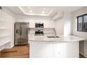 Modern kitchen features stainless steel appliances, granite countertops, and bright lighting at 2685 S Dayton Way # 234, Denver, CO 80231