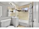 Clean bathroom featuring a bathtub, shower, vanity, and neutral tilework at 7831 Hollywood St, Commerce City, CO 80022