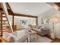 Bright living room with wood beams, fireplace, and stylish furniture on top of soft rug at 10179 S Turkey Creek Rd, Morrison, CO 80465