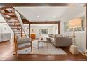 Inviting living room with wood floors, open staircase, and modern decor at 10179 S Turkey Creek Rd, Morrison, CO 80465