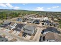 An aerial shot showcases the neighborhood's layout and mountain views in the distance at 4581 S Kipling Cir, Denver, CO 80123