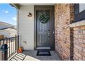 The front door, adorned with a wreath, welcomes you to this inviting home at 4581 S Kipling Cir, Denver, CO 80123