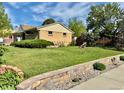 A large backyard with a lawn and retaining wall at 3531 E 91St Ave, Thornton, CO 80229