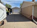 A long driveway leading to a detached garage in the backyard at 3531 E 91St Ave, Thornton, CO 80229