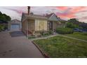 Cozy home exterior featuring a garage, and a yard, captured during a colorful sunset at 3531 E 91St Ave, Thornton, CO 80229