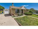 Quaint single-story home with a detached garage, a well-kept lawn, and mature landscaping at 3531 E 91St Ave, Thornton, CO 80229