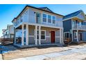 Attractive two-story home with gray siding, a red door and a balcony for enjoying neighborhood views at 46554 Avery Ln, Bennett, CO 80022