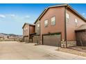 Modern townhome featuring attached garages and beautiful mountain views from a quiet neighborhood at 8437 Mount Kataka Loop, Littleton, CO 80125