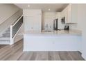 Modern kitchen with white cabinets, stainless steel appliances, and spacious island at 8887 San Antonio St, Littleton, CO 80125