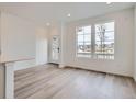 Bright living room featuring wood floors, lots of natural light, and neutral walls at 8887 San Antonio St, Littleton, CO 80125