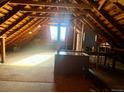 Spacious attic featuring a large window and exposed beams, with potential for customization at 241 W 4Th Ave, Denver, CO 80223