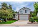 Charming two-story home with mature trees, a well-maintained lawn, and a two-car garage at 2940 E Yarrow Cir, Superior, CO 80027