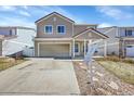 Two-story home featuring an attached garage, cozy front porch, and well-manicured lawn in a friendly neighborhood at 5214 Perth Ct, Denver, CO 80249