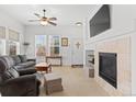Bright living room with fireplace, plush seating, and large windows offering natural light at 5899 S Taft Ter, Littleton, CO 80127