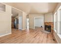 Spacious living room featuring a stone fireplace, wood floors, and abundant natural light with an open concept at 140 Beaver Rd, Idaho Springs, CO 80452