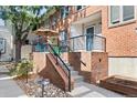 Brick front porch with a patio set, umbrella, and wrought-iron railing at 152 S Jackson St, Denver, CO 80209