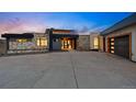 Modern home exterior showcasing stone accents, black trim, and a spacious concrete driveway at 545 Strada Rossa Rd, Golden, CO 80401