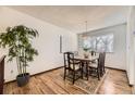 Bright dining room with hardwood floors, chandelier, and large window at 1348 E Jamison Ave, Centennial, CO 80122
