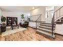 Open living room with hardwood floors, fireplace, and staircase to the upper level at 1348 E Jamison Ave, Centennial, CO 80122